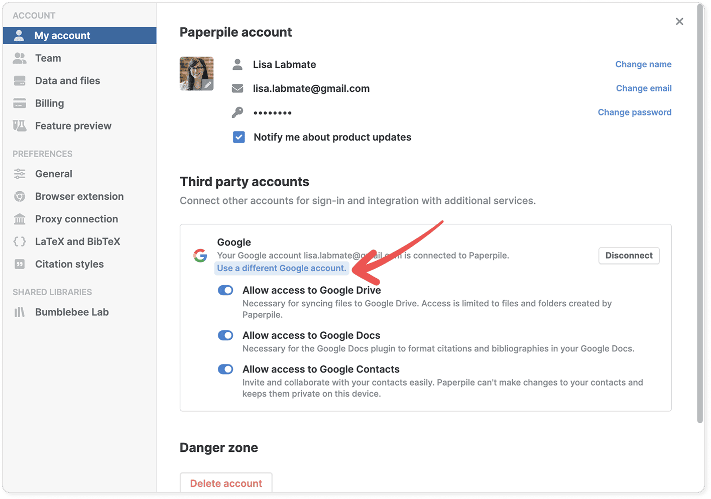 Settings › My account with a red arrow pointing to the highlighted “Use a different Google account.” link under Third party accounts, beside a Disconnect button and toggles for Drive, Docs and Contacts.